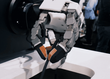 Robotic gripper performing an industrial manipulation demo with multimodal tactile sensing